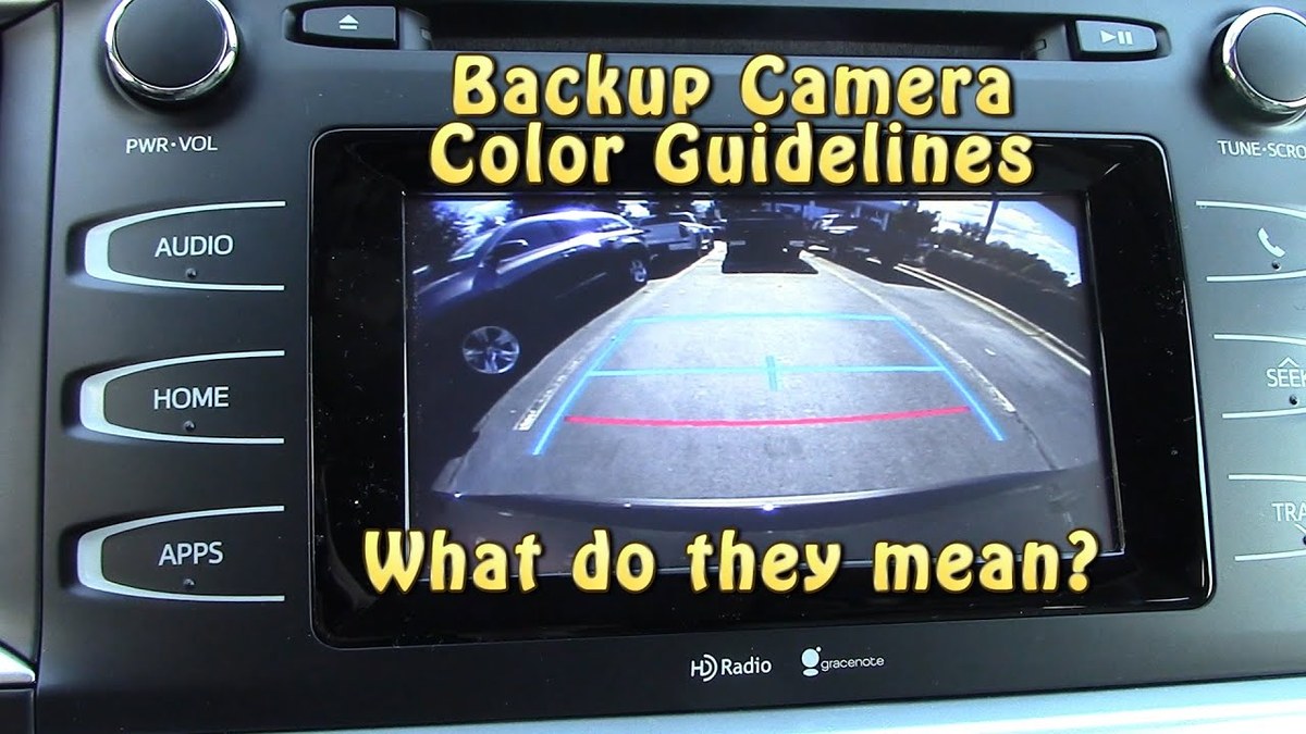 Backup camera display showing static guide lines on a car's rearview screen during diagnostic inspection.